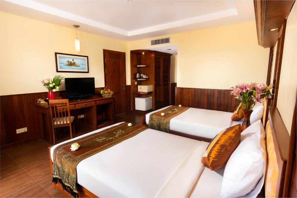 Postel nebo postele na pokoji v ubytování City River Hotel