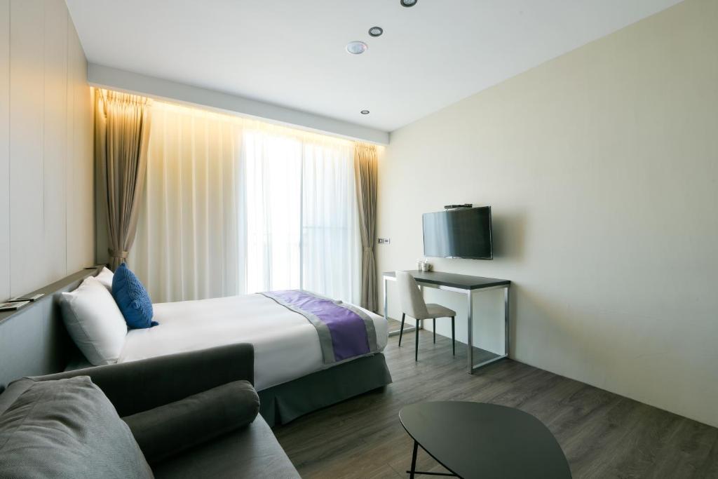 Postel nebo postele na pokoji v ubytování Hotel Hesper HSR Taichung