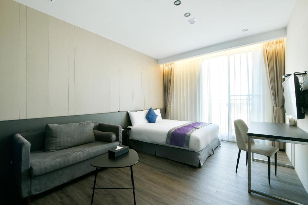 Postel nebo postele na pokoji v ubytování Hotel Hesper HSR Taichung