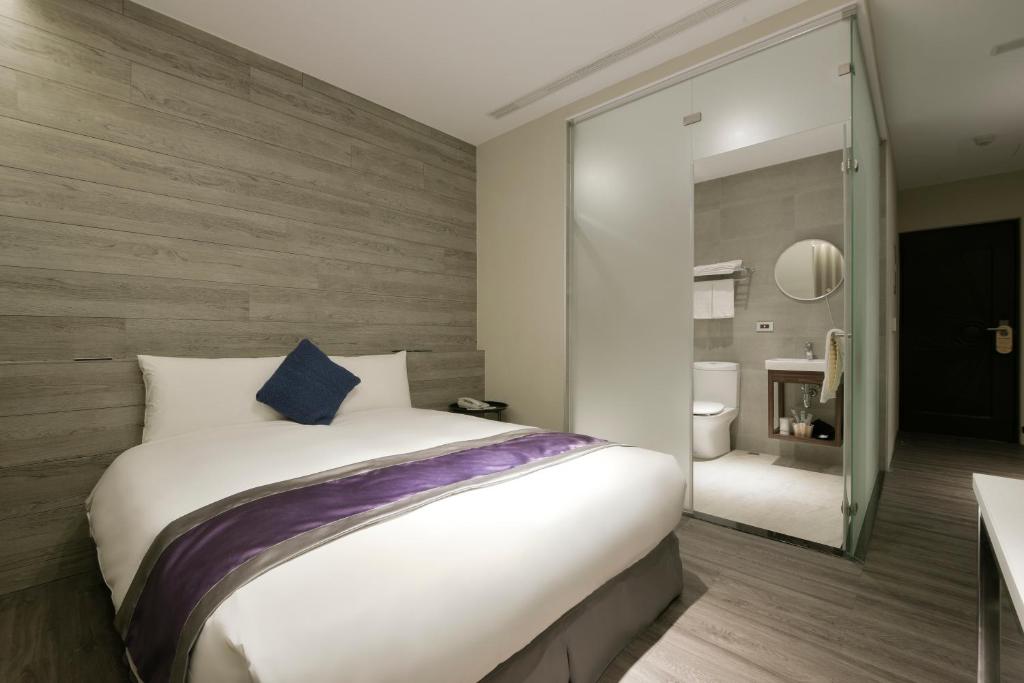 Postel nebo postele na pokoji v ubytování Hotel Hesper HSR Taichung