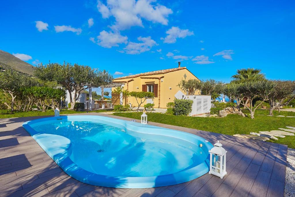 a swimming pool in a yard with a house at Villa Gaia - Scopello-Villas in Scopello