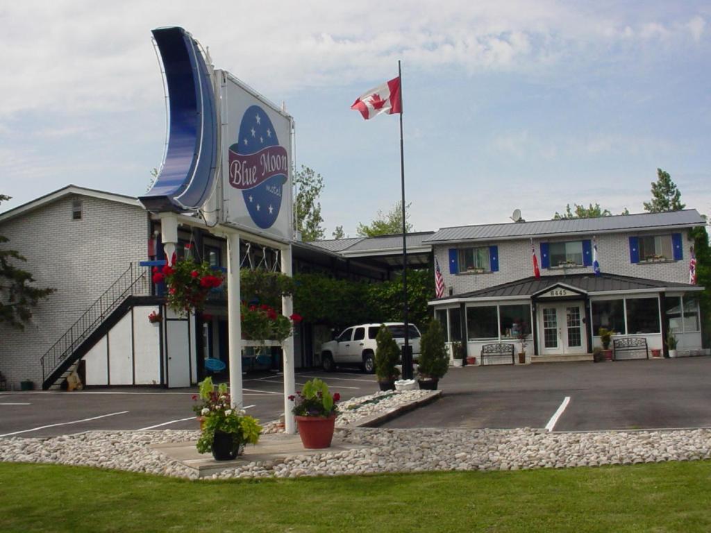 a large white building with a flag on top of it at Blue Moon Motel in Niagara Falls