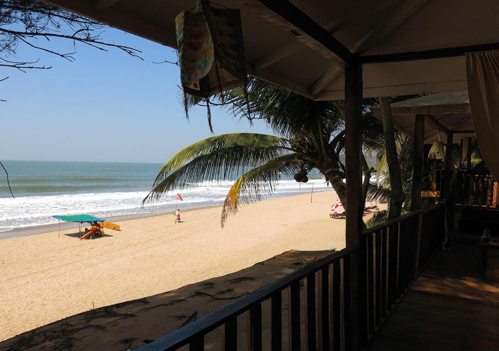 a view of the beach from a balcony of a beach at Jardim a Mar in Agonda