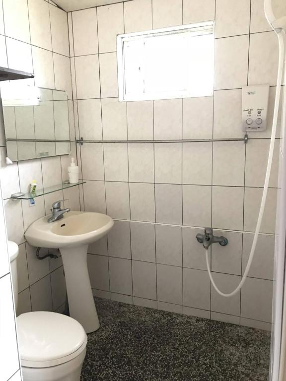 a bathroom with a toilet and a sink at One House in Gongliao