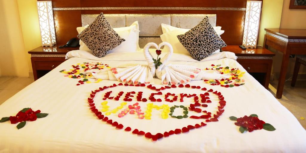 a bed with a valentines heart on it at Vamos Guest House in Addis Ababa
