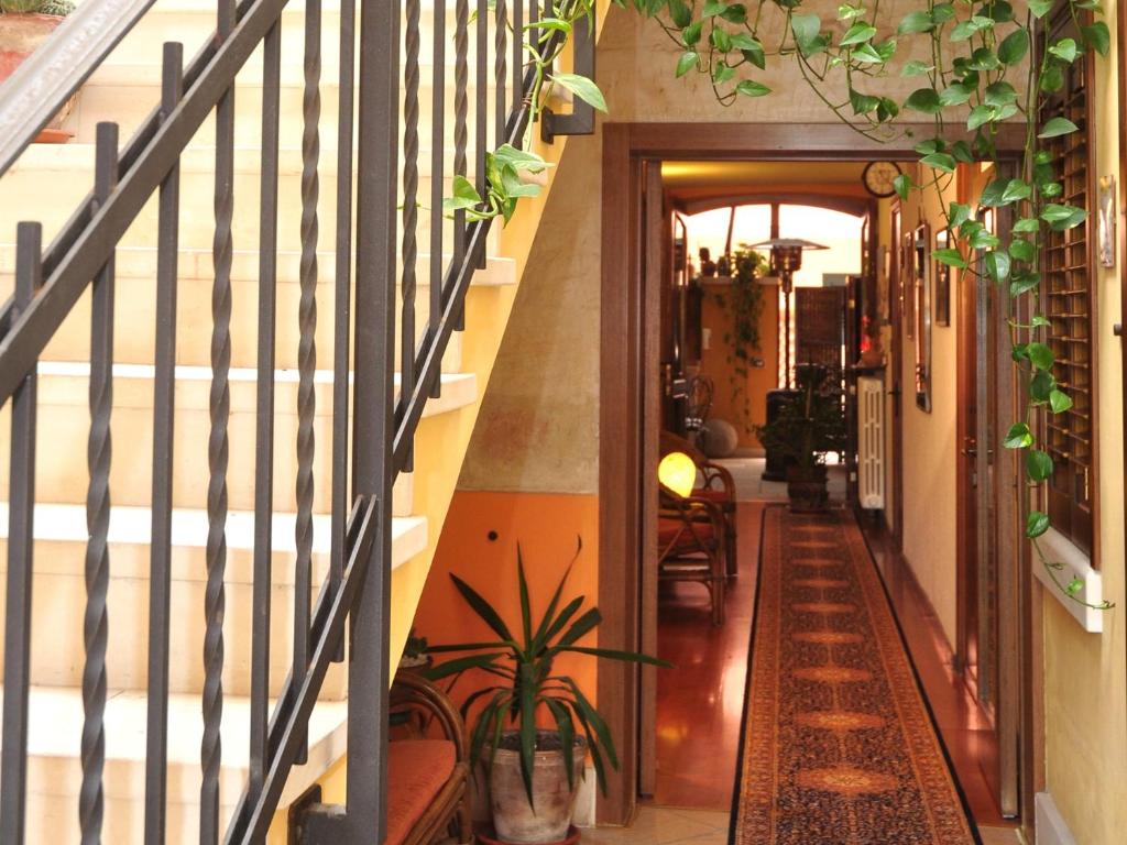 a hallway with stairs and plants in a house at B&B Viaprimaldo Camere in Otranto