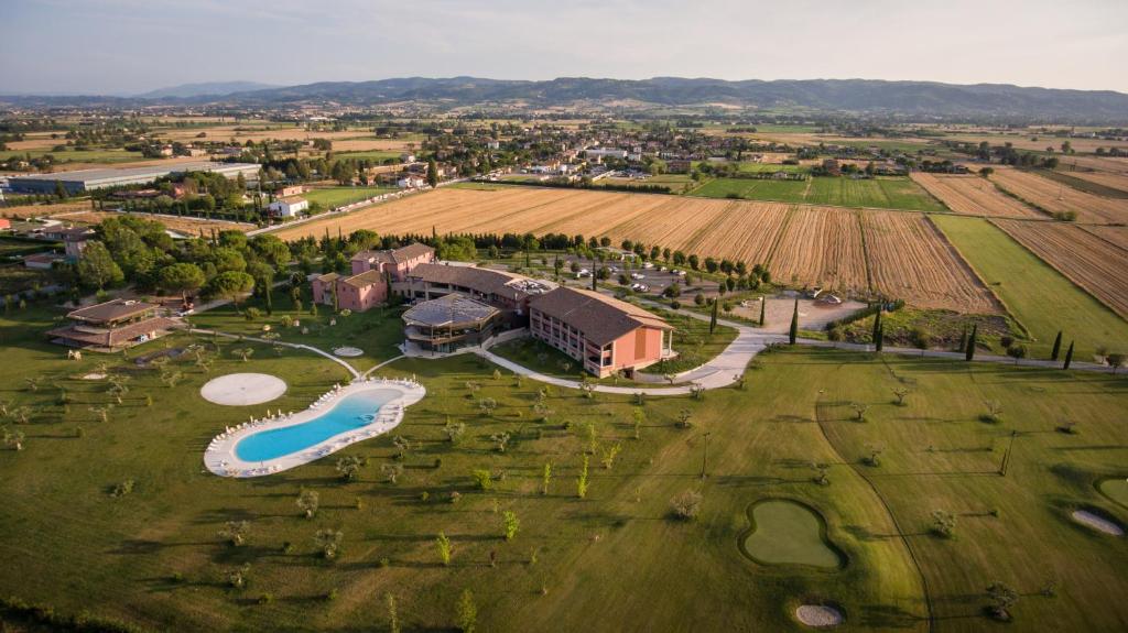 an aerial view of a resort with a pool and a field at Valle di Assisi Hotel & Spa in Assisi
