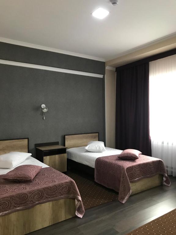 Postel nebo postele na pokoji v ubytování ORIENT