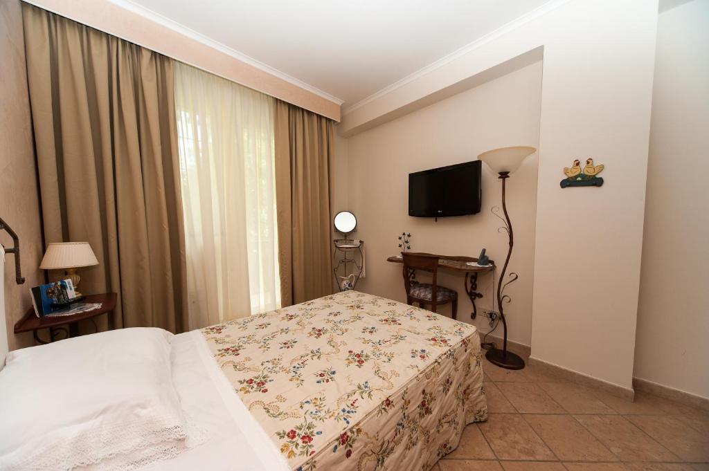 Postel nebo postele na pokoji v ubytování Albergo La Primula