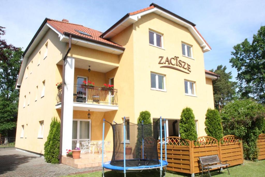 a building with a playground in front of it at Zacisze Konopnickiej in Pobierowo
