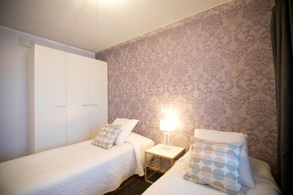 Postel nebo postele na pokoji v ubytování Majesteetti Apartments