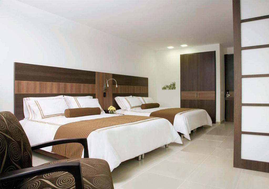 Postel nebo postele na pokoji v ubytování San Simon Hotel Pereira By Soratama