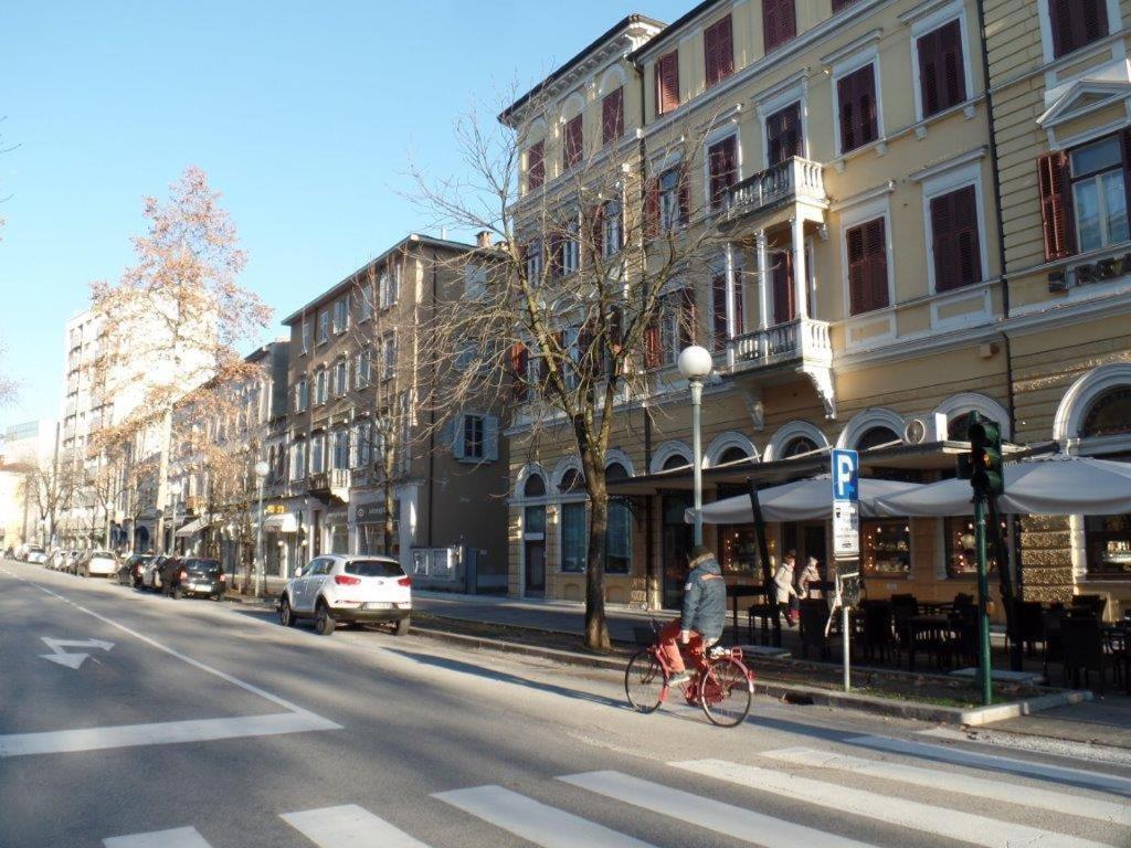 a person riding a bike on a city street at Residenza Vittorio Emanuele in Gorizia