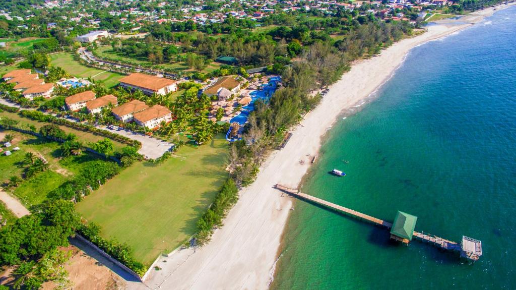 an aerial view of a beach and the ocean at La Ensenada Beach Resort in Tela