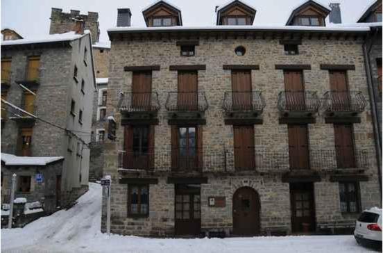 a large brick building with balconies on the side of it at Casa Felices in Broto