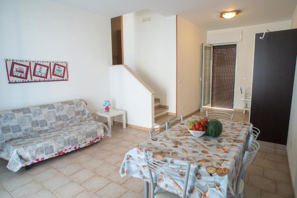 salon z kanapą i stołem w obiekcie Appartamenti a 50 mt dal mare w mieście Torre San Giovanni Ugento