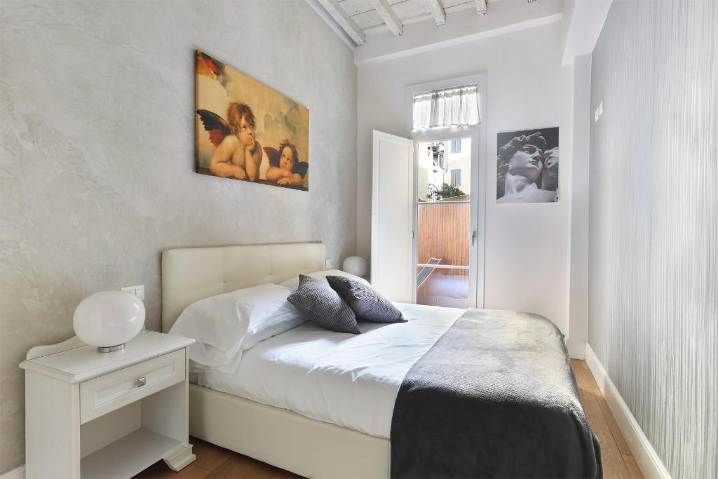 1 dormitorio con 1 cama y una foto en la pared en Ginori, en Florencia