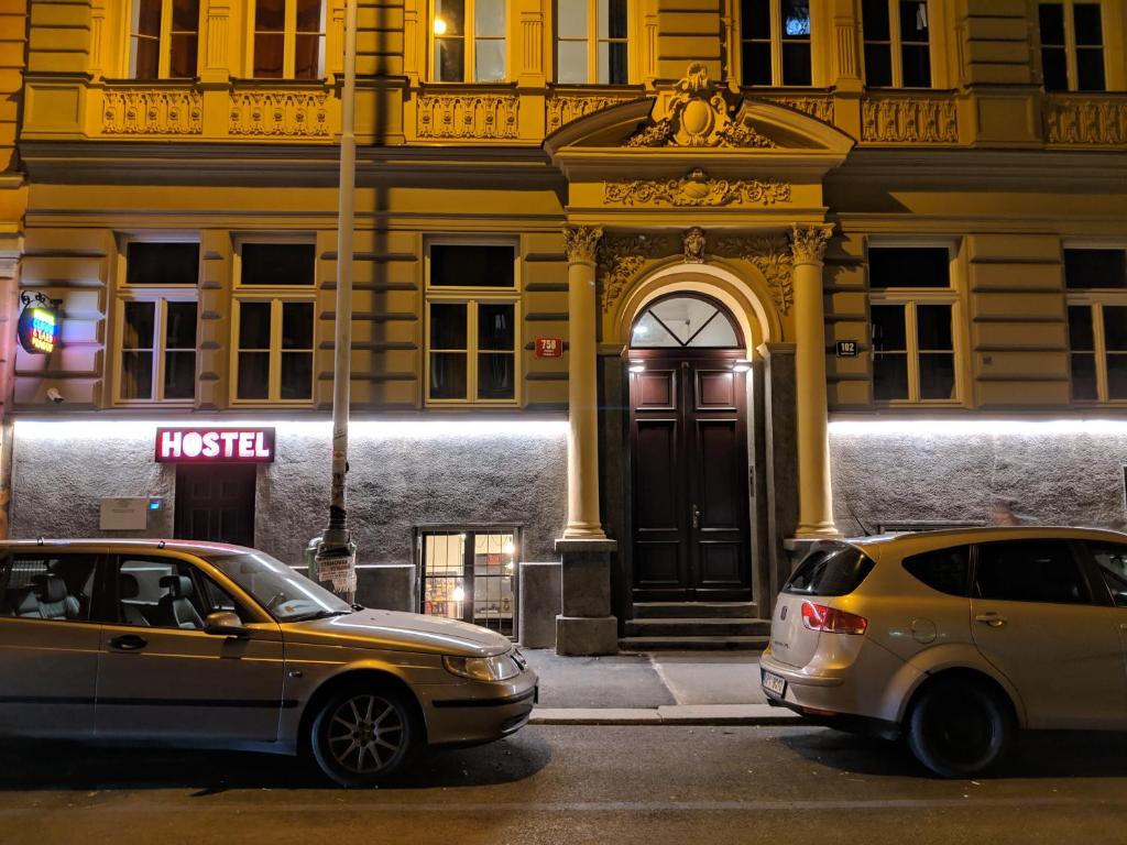 two cars parked in front of a building at Clown and Bard Hostel in Prague