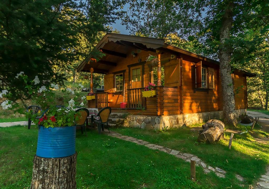 Cabaña de madera con mesa y árbol en Cabañas de Madera Sanabria, en Vigo de Sanabria