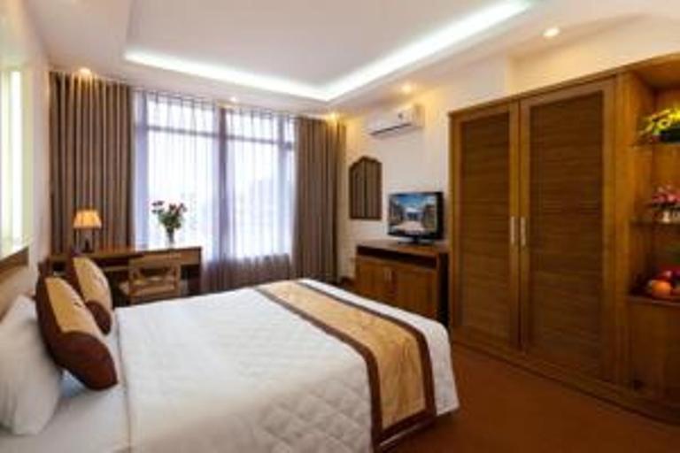 a hotel room with a bed and a television at Lam Bao Long Hotel in Hue