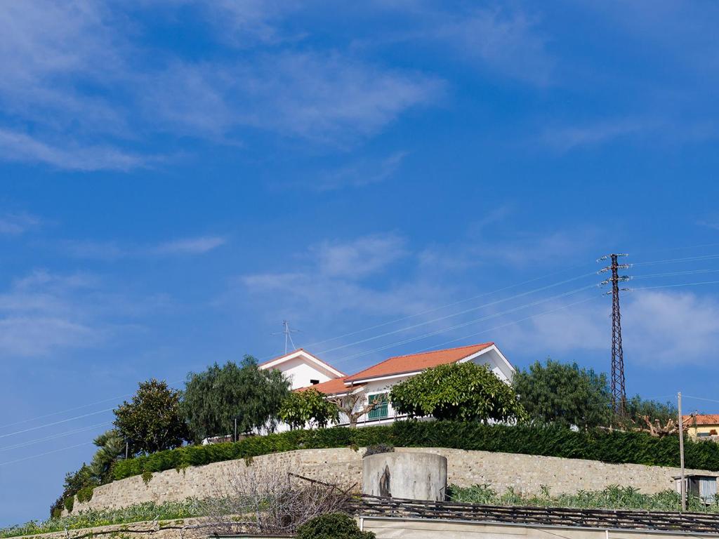 a house sitting on top of a hill at Agrilea in Santo Stefano al Mare