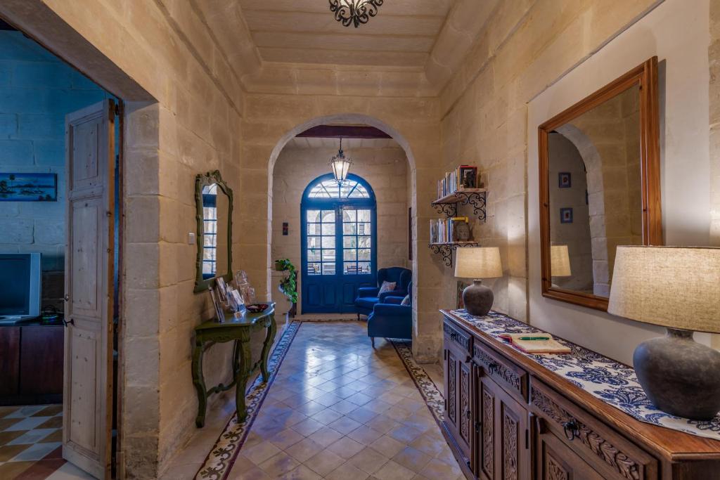 a living room with a table and a blue door at The Stonehouse in St. Julianʼs