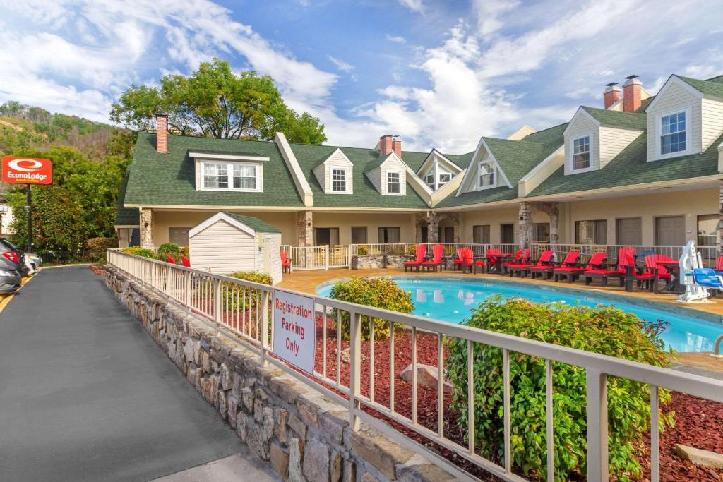 a home with a swimming pool in front of a house at Econo Lodge Inn & Suites at the Convention Center in Gatlinburg