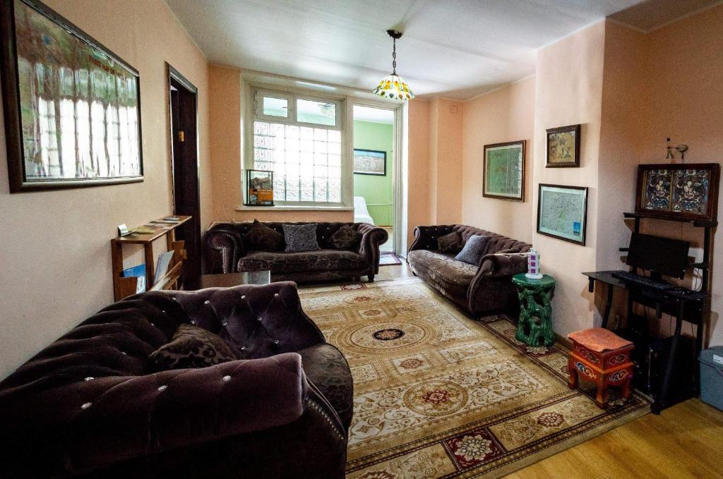 a living room with two couches and a rug at Lotus Guesthouse in Ulaanbaatar