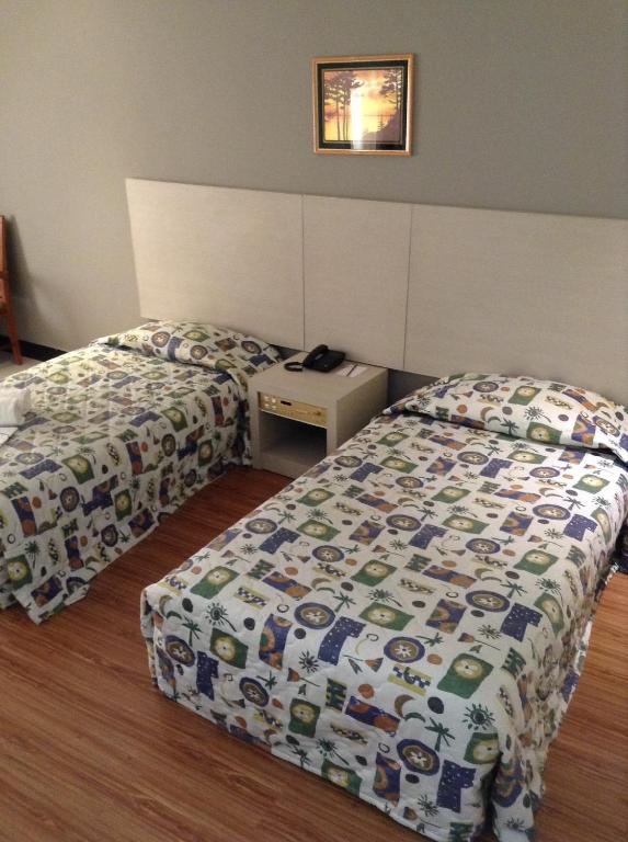 Postel nebo postele na pokoji v ubytování Purnama Hotel