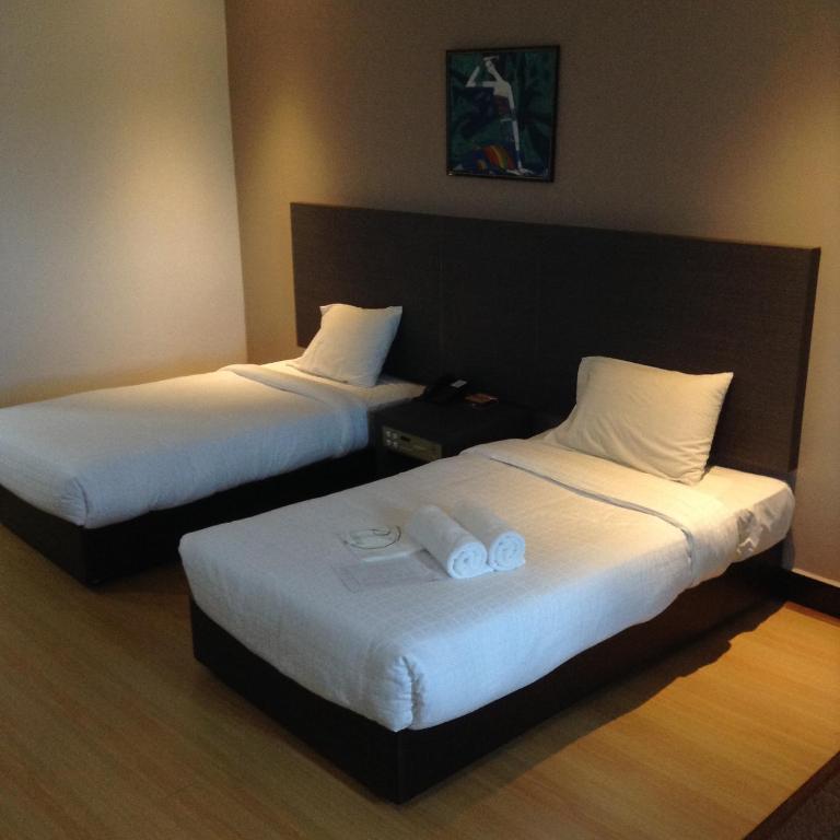 Postel nebo postele na pokoji v ubytování Purnama Hotel