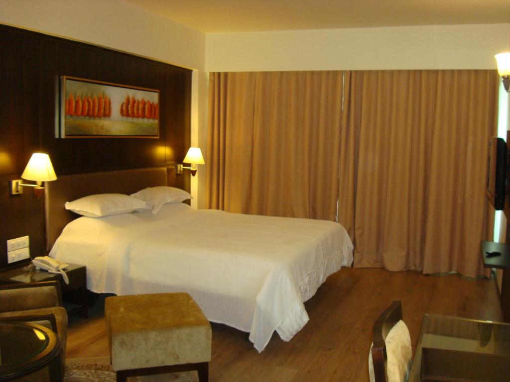 Postel nebo postele na pokoji v ubytování The President-A Boutique Hotel