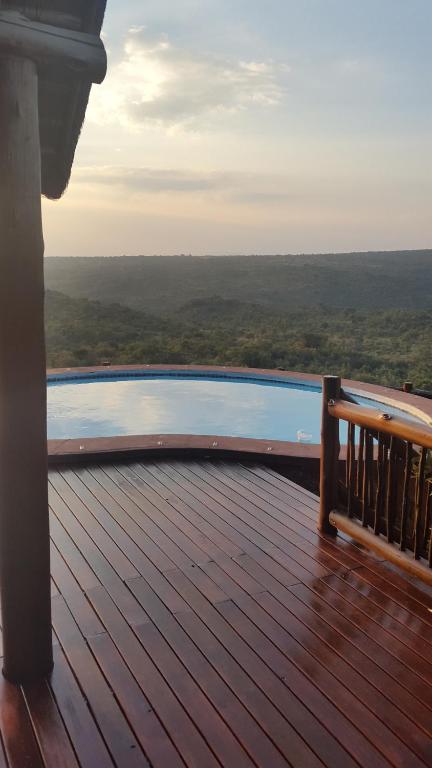 una terraza de madera con piscina en una casa en Sunset Private Game Lodge Mabalingwe, en Bela-Bela