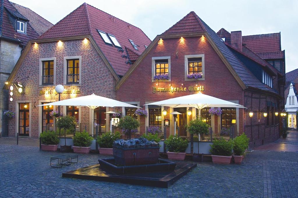 a large building with a fountain in front of it at Hotel Domschenke in Billerbeck