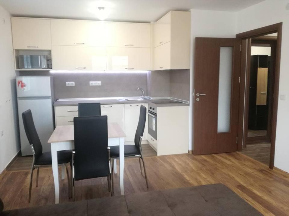 a kitchen and dining room with a table and chairs at Fashion Apartments in Sandanski