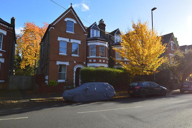 a house with a tarp on the side of the street at 2 bedroom top floor flat, West Dulwich in London