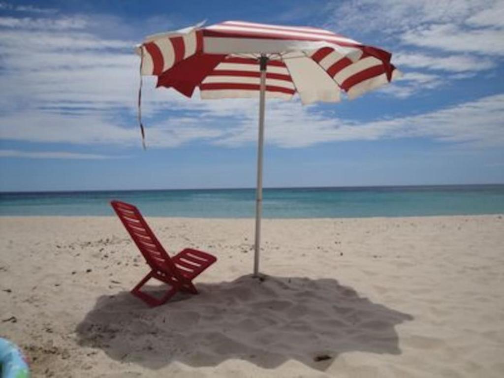 a chair and an umbrella on the beach at Villa Stella in Pula