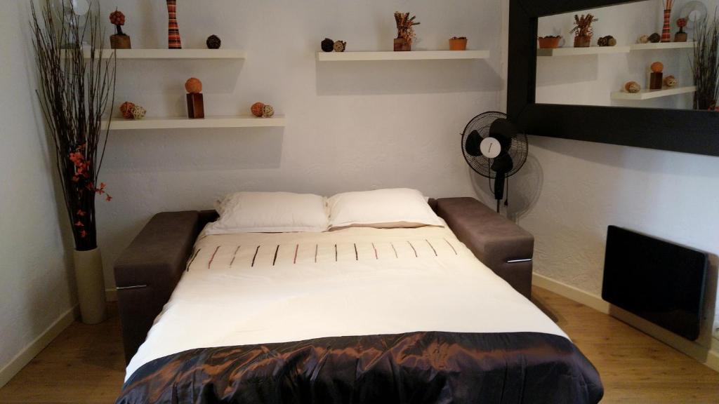 a large bed in a room with shelves at Coeur de Cannes Forville - Vieux Port Palais Plage in Cannes