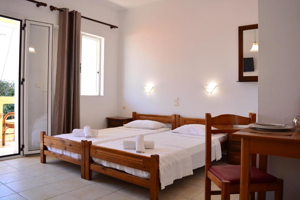 A bed or beds in a room at Raph's Studios-Apts By The Sea