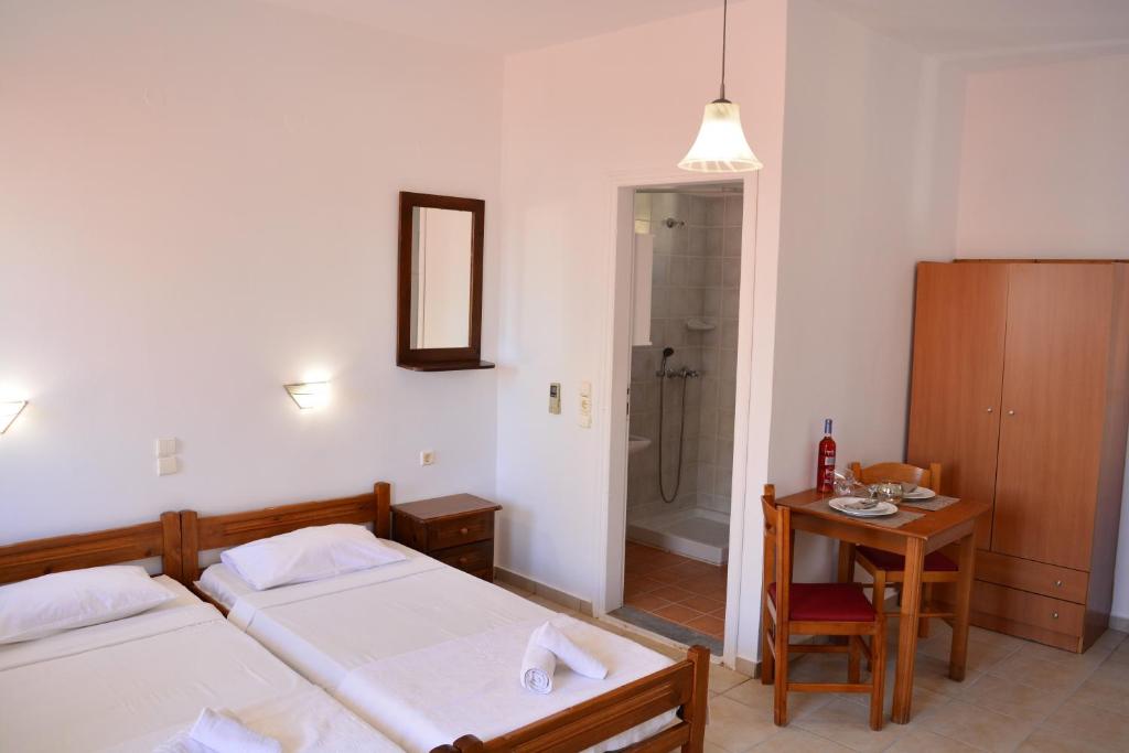 A bed or beds in a room at Raph's Studios-Apts By The Sea