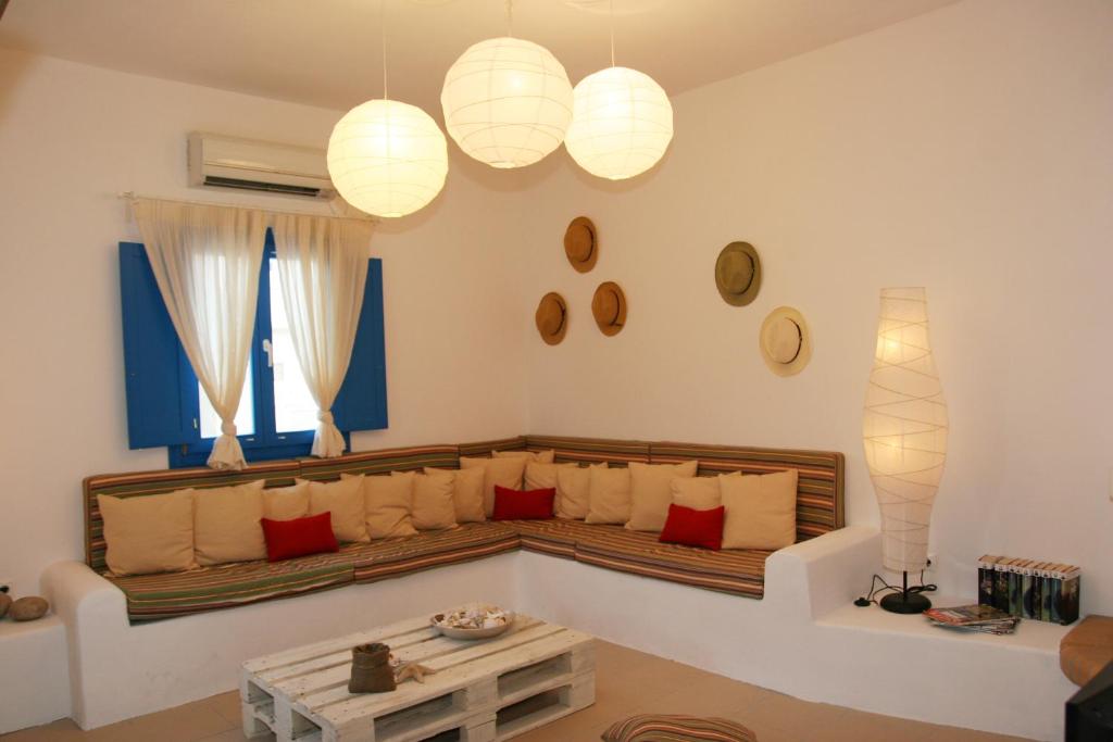 a living room with a couch and a table at Blue Meadow in Livadi Astypalaias