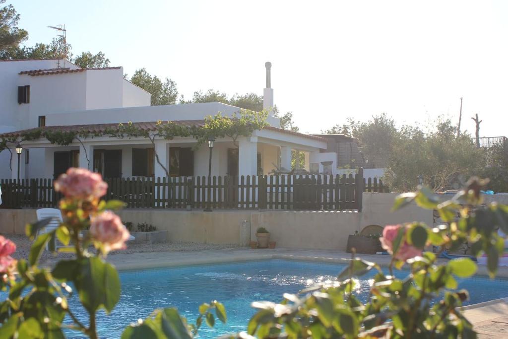 a house with a swimming pool in front of a house at Ca na Lidia d’en Carlos in La Mola