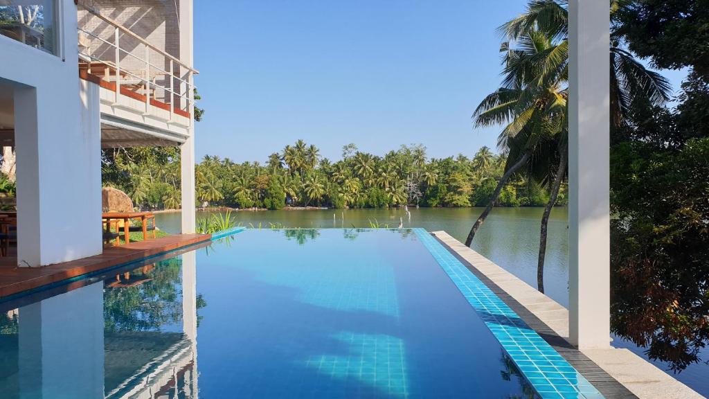 a swimming pool with a view of a river at 33 Lake Terrace in Hikkaduwa