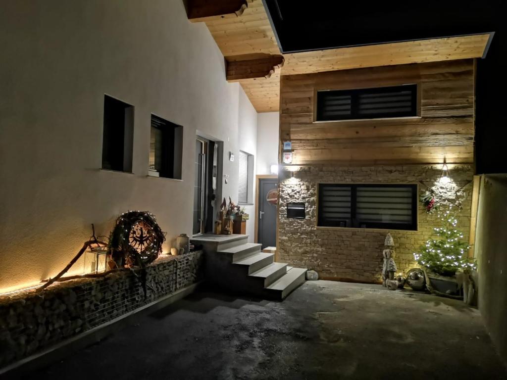 a hallway of a house with a christmas tree and stairs at Apart Auszeit in Wenns