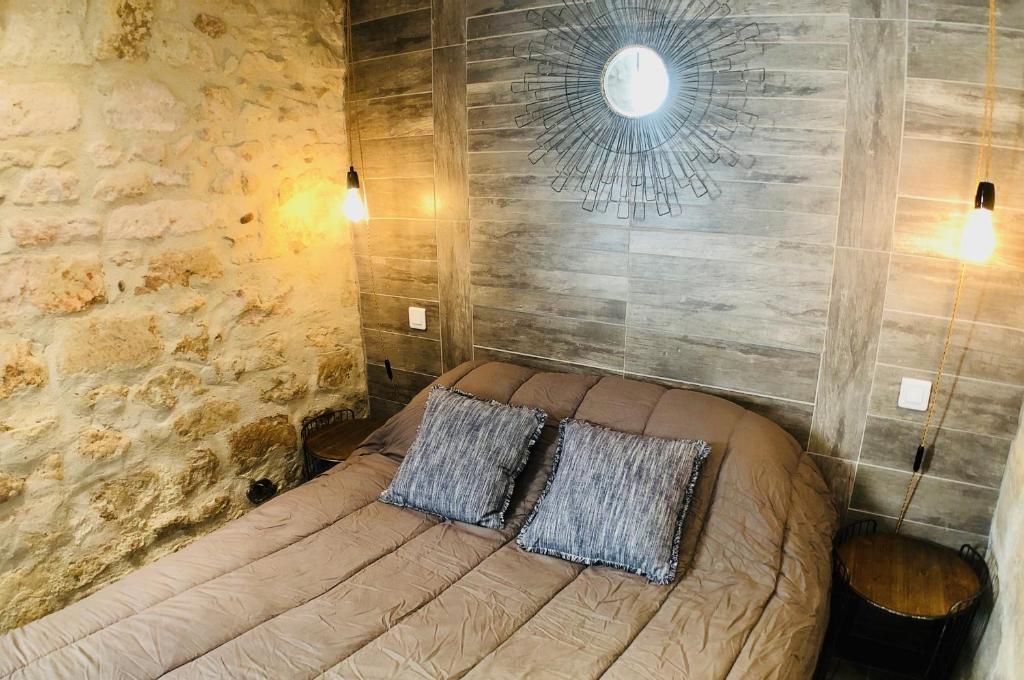 a bedroom with a bed with two pillows on it at Mas Guiraud, un instant rêvé in Beaucaire