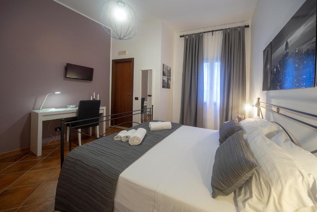 Postel nebo postele na pokoji v ubytování Holiday Rooms Portale Pirrera