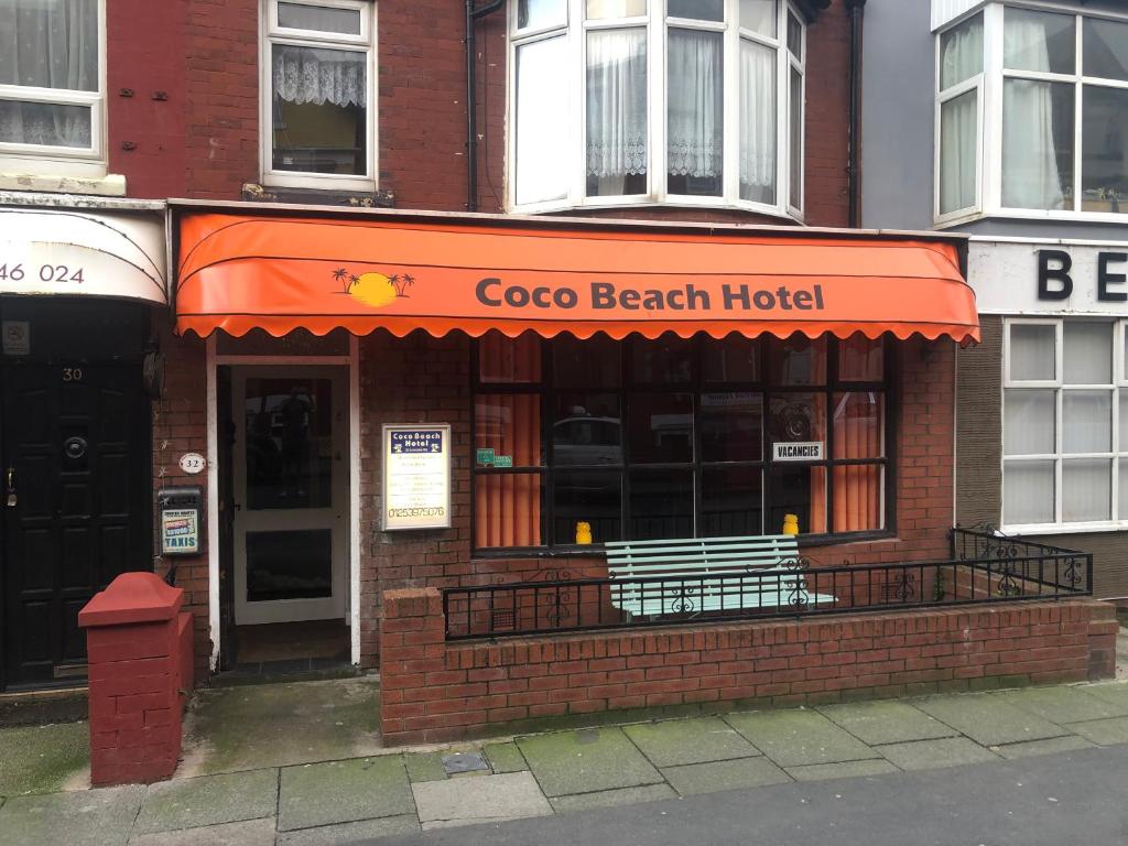 a restaurant with an orange awning on a building at Coco Beach Hotel in Blackpool