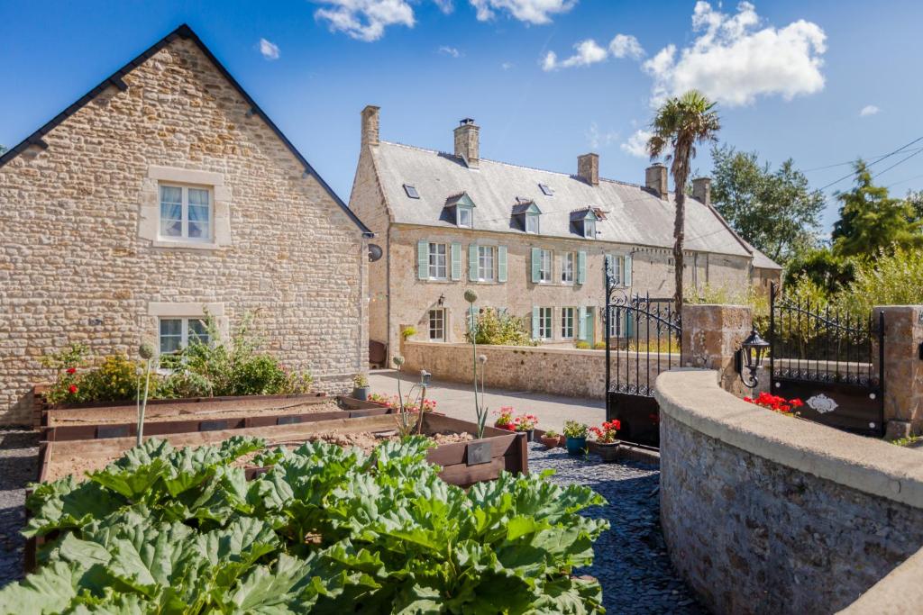 a house with a garden in front of it at The Old Farm of Amfreville in Amfreville