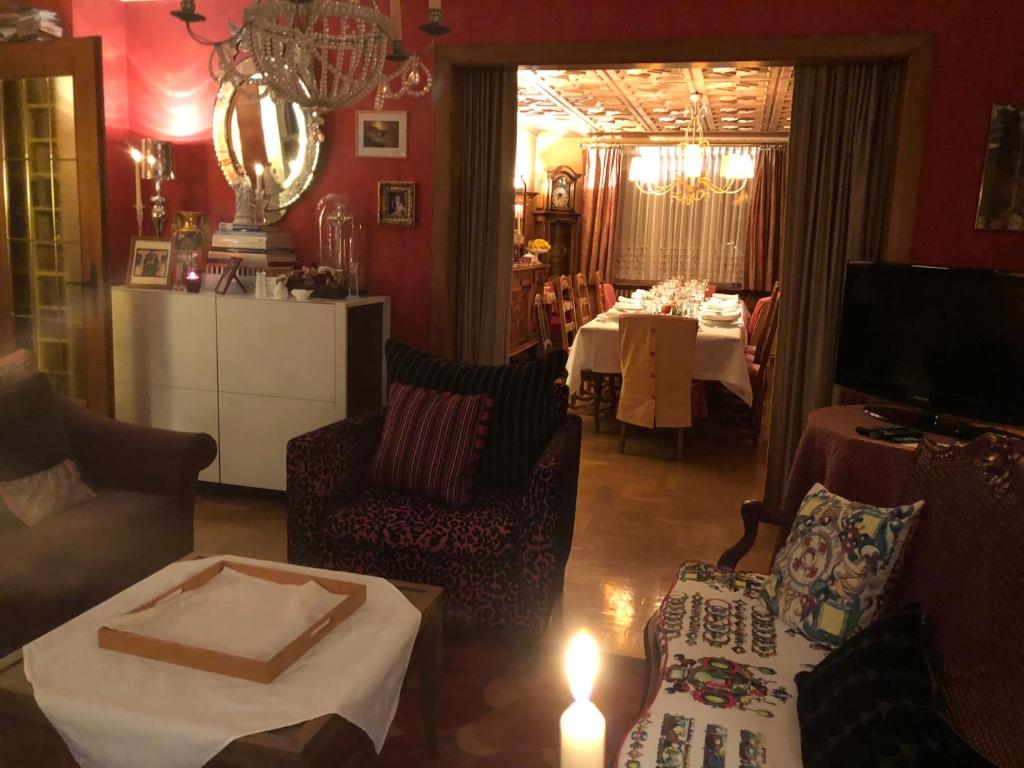 a living room with a table and a dining room at La Maison de juliette in Saint-Hippolyte