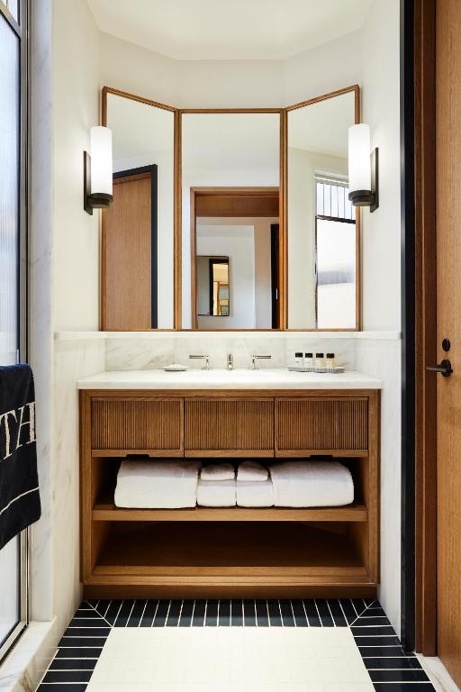a bathroom with a sink and a mirror at Shinola Hotel in Detroit