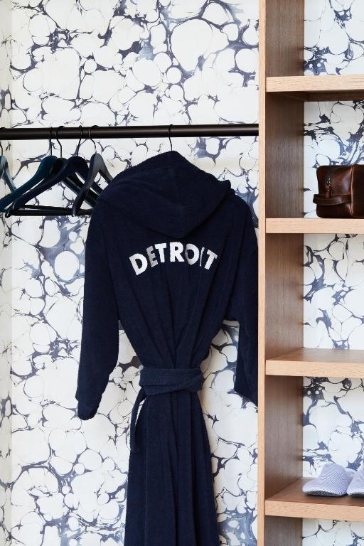 a shirt hanging on a shelf with a shirt at Shinola Hotel in Detroit
